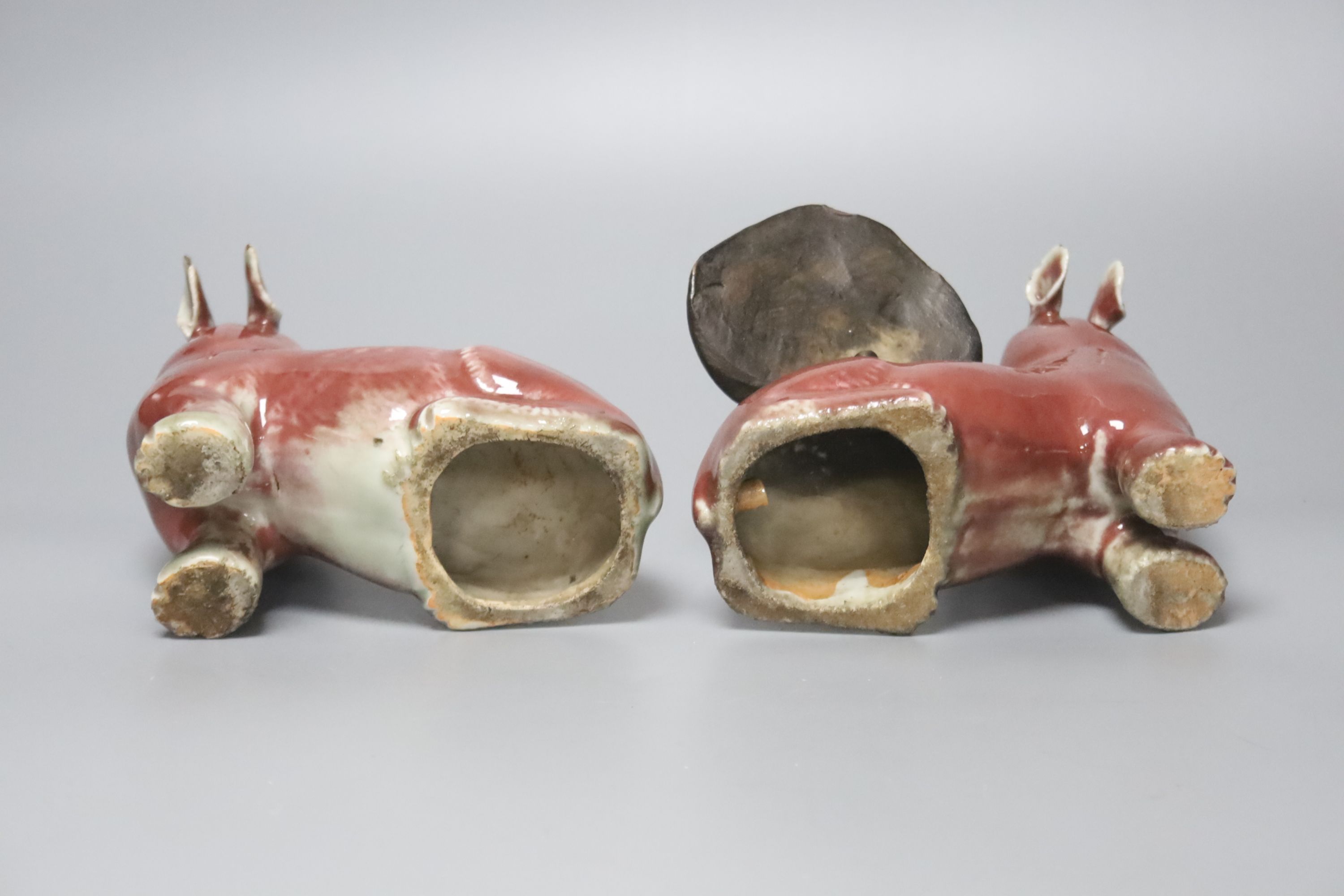 A pair of unusual Chinese copper red glazed pig incense burners/ joss stick holders, late Qing dynasty, height 13cm